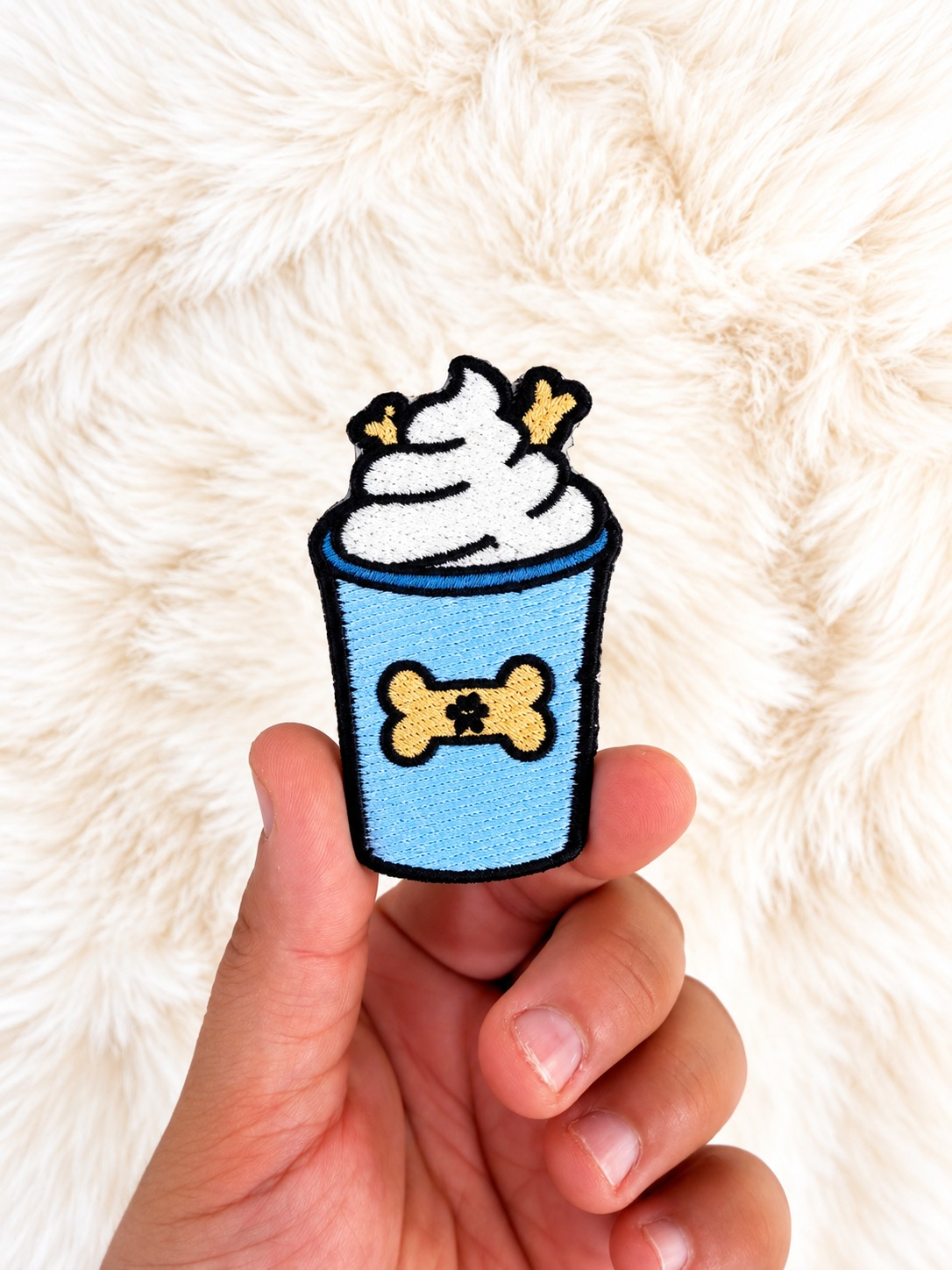 Puppuccino velcro patch, in hand